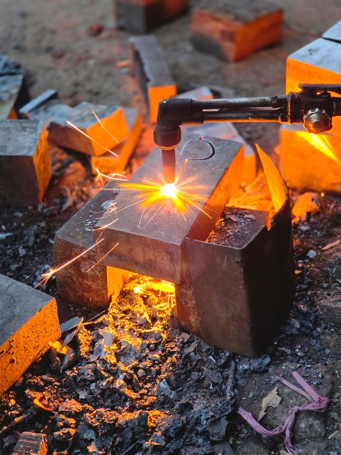 Close-up of metal welding with sparks in an outdoor workshop in Sialkot, Pakistan.
