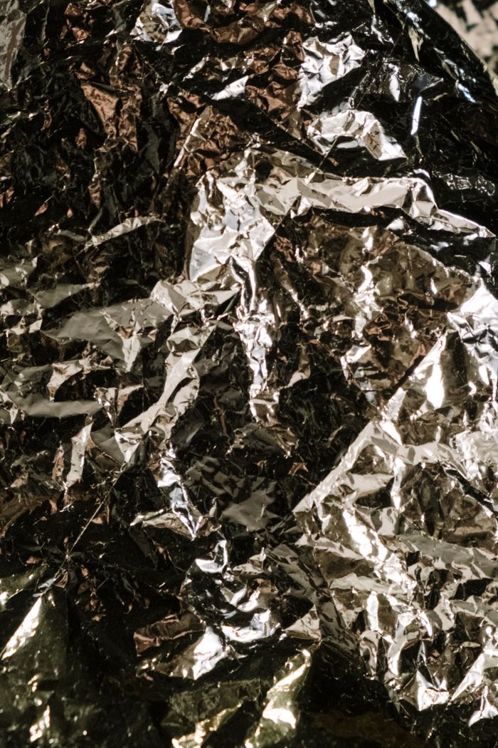 A close-up of crumpled aluminum foil showcasing its metallic texture and shine.
